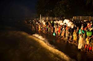 Burundian refugees, mostly women and children, wait on the shore of Lake Tanganyika to be transferred by boat to Kigoma and then on to Nyaragusu refugee camp.