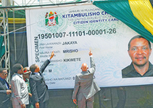 President Jakaya Kikwete admires his national identity card prepared by the National Identification Authority (NIDA). The ID project came into fruition during the Fourth Phase Government tenure 