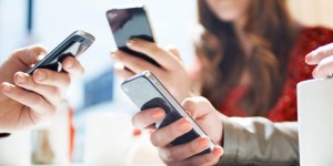 hands texting with mobile phones in cafe