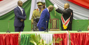 Burundi's President Pierre Nkurunziza (C) is adorned with a symbolic chain after being sworn in for a controversial third term in power at the Congress Palace in Kigobe district, Bujumbura, on August 20, 2015. PHOTO | GRIFF TAPPER |  AFP