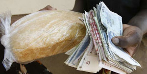  A Zimbabwean purchases bread with the Zimbabwe dollar equivalent to $2 in 2008. Zimbabweans were now facing a new scourge: Deflation, which economists say is worse than hyperinflation. PHOTO | AFP  By KITSEPILE NYATHI 